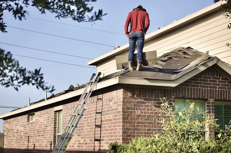 Professional roofer working on a residential roof in Fairview Knolls